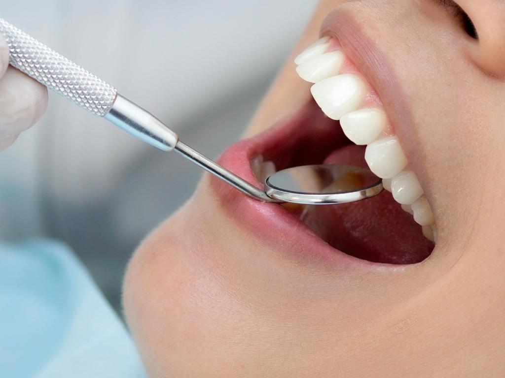 Dental examination with a dental mirror at a dental clinic in Jayanagar for comprehensive oral health care.